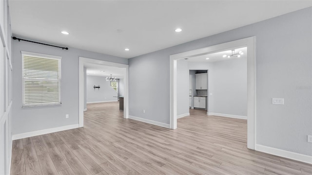 1095 Woodland Oaks Dr, Lakeland, FL 33813 - unfurnished room featuring a chandelier, light wood-style flooring, recessed lighting, and healthy amount of natural light