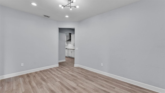 1095 Woodland Oaks Dr, Lakeland, FL 33813 - empty room with light wood-type flooring, a chandelier, and recessed lighting