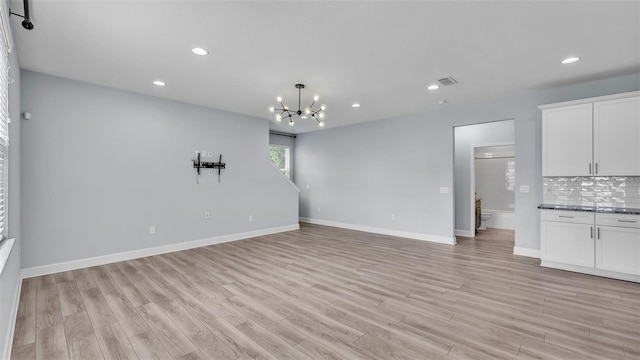 1095 Woodland Oaks Dr, Lakeland, FL 33813 - unfurnished living room with a chandelier, light wood finished floors, and recessed lighting
