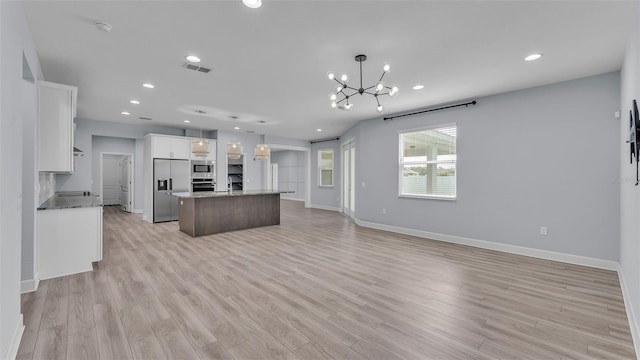 1095 Woodland Oaks Dr, Lakeland, FL 33813 - kitchen with stainless steel appliances, a chandelier, light wood-style flooring, recessed lighting, and open floor plan