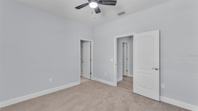 1095 Woodland Oaks Dr, Lakeland, FL 33813 - unfurnished bedroom featuring light carpet and ceiling fan