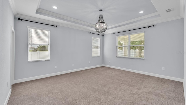 1095 Woodland Oaks Dr, Lakeland, FL 33813 - empty room featuring a tray ceiling, ornamental molding, a chandelier, recessed lighting, and carpet