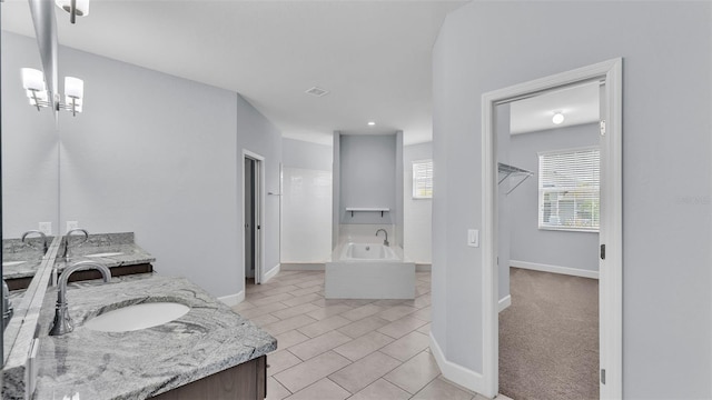 1095 Woodland Oaks Dr, Lakeland, FL 33813 - bathroom with vanity, a garden tub, and tile patterned floors