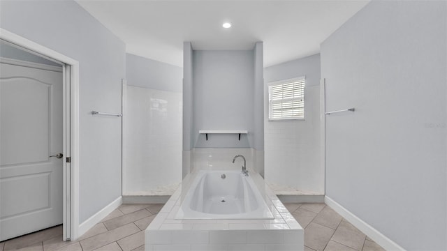 1095 Woodland Oaks Dr, Lakeland, FL 33813 - bathroom with a garden tub, walk in shower, and tile patterned floors