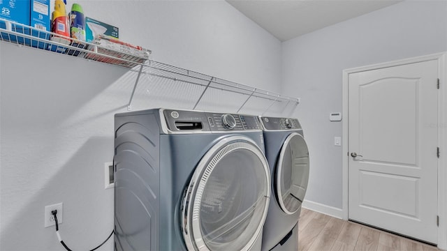 1095 Woodland Oaks Dr, Lakeland, FL 33813 - washroom featuring separate washer and dryer and light wood-style flooring