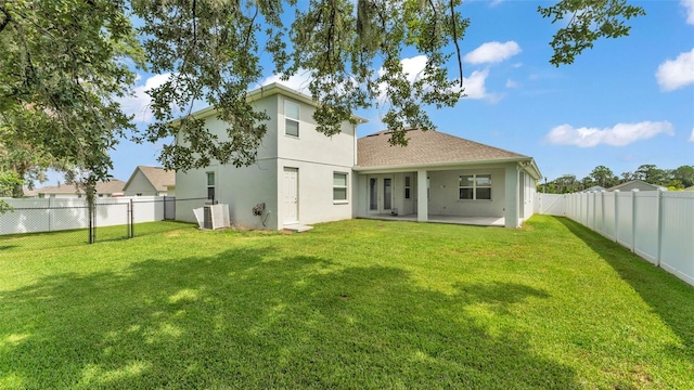 1095 Woodland Oaks Dr, Lakeland, FL 33813 - rear view of property featuring stucco siding, a fenced backyard, a patio area, and roof with shingles