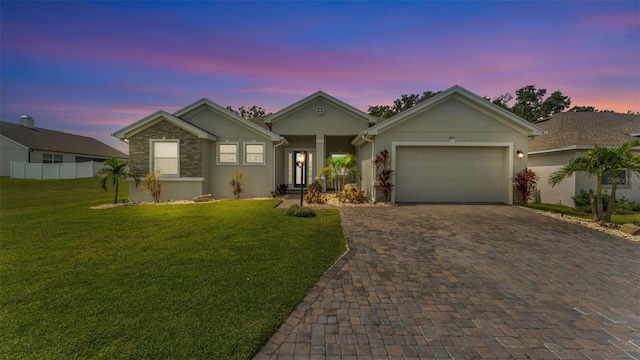 1095 Woodland Oaks Dr, Lakeland, FL 33813 - ranch-style home with stucco siding, decorative driveway, and a garage