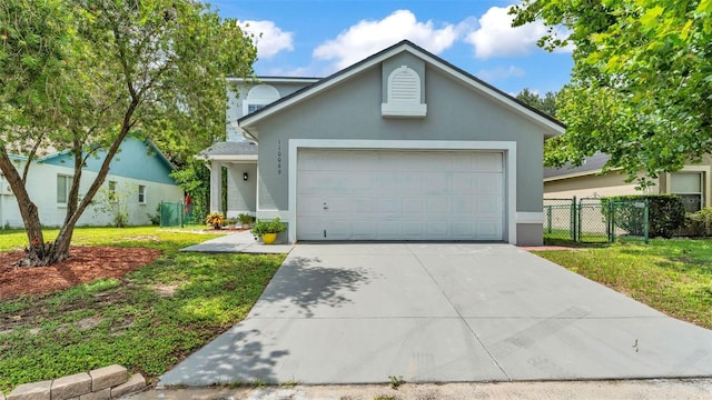1100 Lowry Ave Unit 69, Lakeland, FL 33801 - view of front of house featuring stucco siding, driveway, and a garage