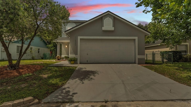 1100 Lowry Ave Unit 69, Lakeland, FL 33801 - view of front facade featuring concrete driveway, an attached garage, and stucco siding