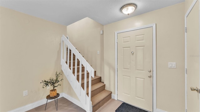1100 Lowry Ave Unit 69, Lakeland, FL 33801 - foyer featuring stairway and baseboards