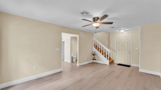 1100 Lowry Ave Unit 69, Lakeland, FL 33801 - empty room with ceiling fan, light wood finished floors, and stairway