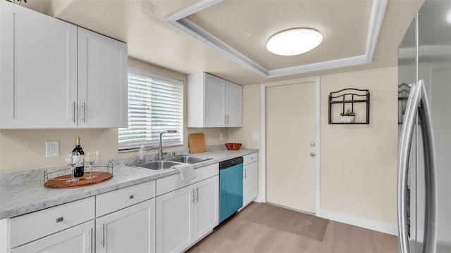 1100 Lowry Ave Unit 69, Lakeland, FL 33801 - kitchen featuring freestanding refrigerator, dishwasher, light wood finished floors, a raised ceiling, and white cabinets