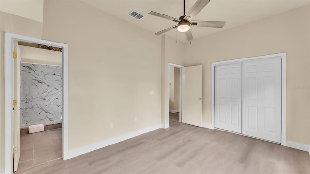 1100 Lowry Ave Unit 69, Lakeland, FL 33801 - unfurnished bedroom featuring light wood-type flooring, a closet, ceiling fan, and connected bathroom