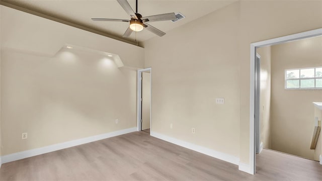 1100 Lowry Ave Unit 69, Lakeland, FL 33801 - unfurnished bedroom with light wood finished floors, vaulted ceiling, and ceiling fan
