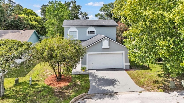 1100 Lowry Ave Unit 69, Lakeland, FL 33801 - view of front of house featuring driveway, stucco siding, an attached garage, roof with shingles, and a front lawn