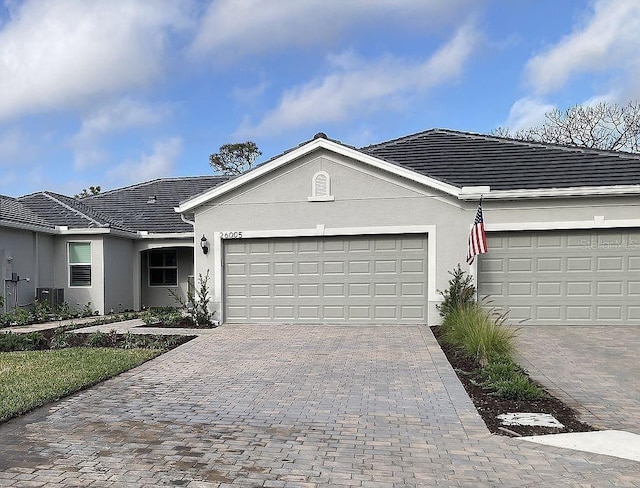 26005 Bimini Sands Ct, Englewood, FL 34223 - single story home featuring decorative driveway, stucco siding, and a garage