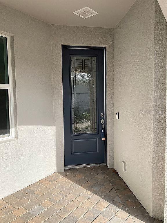 26005 Bimini Sands Ct, Englewood, FL 34223 - view of exterior entry with stucco siding