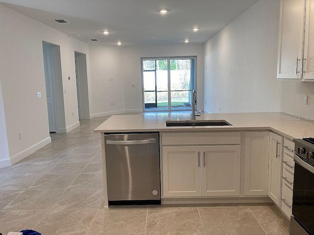 26005 Bimini Sands Ct, Englewood, FL 34223 - kitchen with dishwasher, a peninsula, range, light stone countertops, and light tile patterned floors