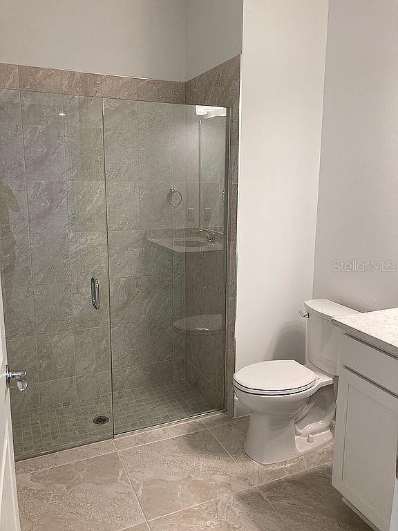 26005 Bimini Sands Ct, Englewood, FL 34223 - full bathroom featuring vanity and a shower stall