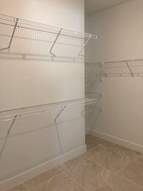 26005 Bimini Sands Ct, Englewood, FL 34223 - walk in closet with tile patterned floors