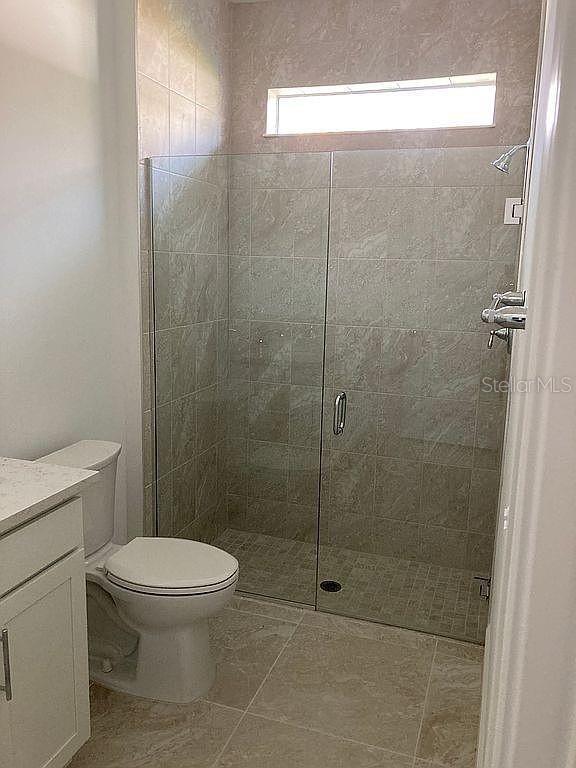 26005 Bimini Sands Ct, Englewood, FL 34223 - full bathroom with vanity and a stall shower