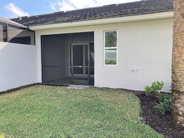 26005 Bimini Sands Ct, Englewood, FL 34223 - rear view of property with a shingled roof, stucco siding, a lawn, and a sunroom