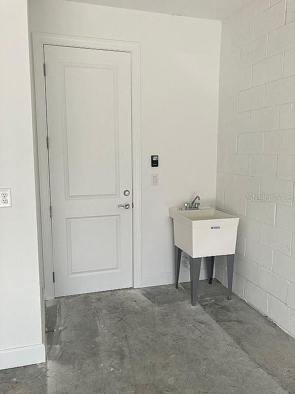26005 Bimini Sands Ct, Englewood, FL 34223 - washroom featuring baseboards and a sink