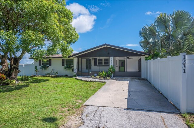 1231 Melville Ave, Lakeland, FL 33805 - ranch-style home featuring driveway, ceiling fan, and a carport
