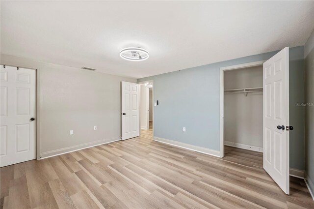 1231 Melville Ave, Lakeland, FL 33805 - unfurnished bedroom with light wood-style flooring and a closet