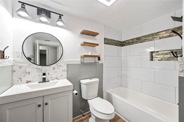 1231 Melville Ave, Lakeland, FL 33805 - bathroom featuring vanity, shower / bath combination, wood finished floors, and decorative backsplash