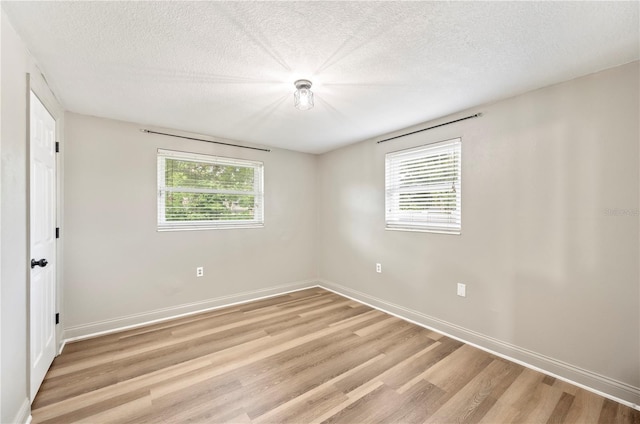 1231 Melville Ave, Lakeland, FL 33805 - empty room with light wood-type flooring and a textured ceiling