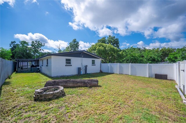 1231 Melville Ave, Lakeland, FL 33805 - fenced backyard with an outdoor fire pit