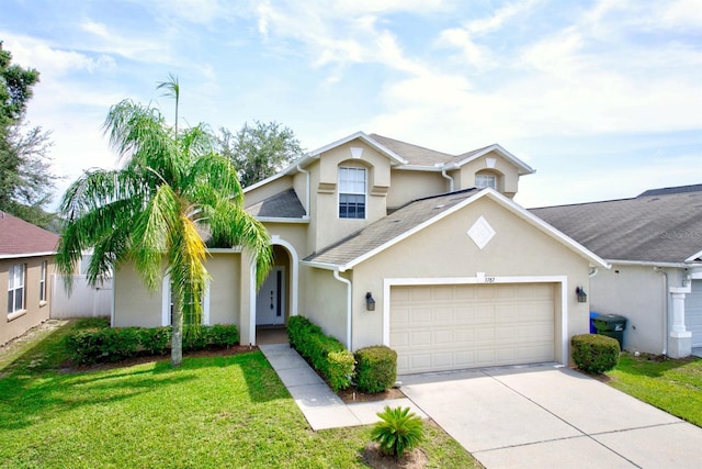 3782 Rollingsford Cir, Lakeland, FL 33810 - traditional-style home with stucco siding, a garage, concrete driveway, and a front yard