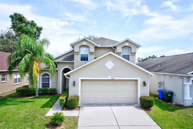 3782 Rollingsford Cir, Lakeland, FL 33810 - view of front of property featuring stucco siding, an attached garage, driveway, and a front lawn