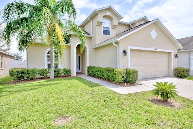 3782 Rollingsford Cir, Lakeland, FL 33810 - view of front of property featuring stucco siding, concrete driveway, a garage, and a front lawn