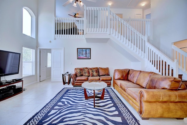 3782 Rollingsford Cir, Lakeland, FL 33810 - living room featuring a high ceiling, ceiling fan, tile patterned flooring, and stairs