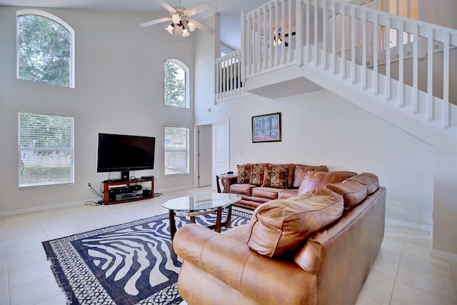 3782 Rollingsford Cir, Lakeland, FL 33810 - living area with a towering ceiling, plenty of natural light, stairway, tile patterned flooring, and ceiling fan