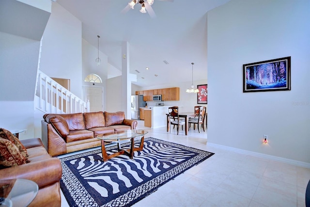 3782 Rollingsford Cir, Lakeland, FL 33810 - living area with high vaulted ceiling, ceiling fan, stairway, and light tile patterned flooring