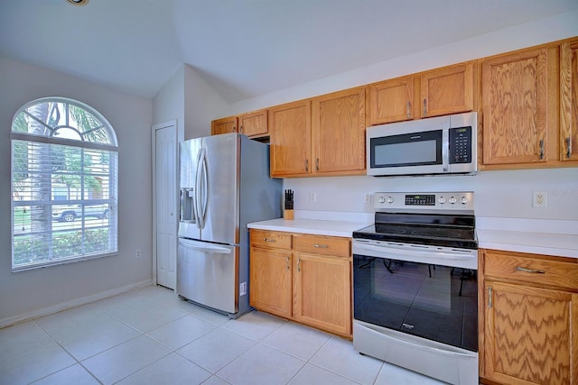 3782 Rollingsford Cir, Lakeland, FL 33810 - kitchen with appliances with stainless steel finishes, light countertops, light tile patterned flooring, and vaulted ceiling