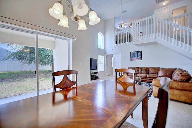 3782 Rollingsford Cir, Lakeland, FL 33810 - dining area with light tile patterned floors, a towering ceiling, a ceiling fan, a chandelier, and stairway