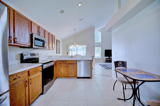 3782 Rollingsford Cir, Lakeland, FL 33810 - kitchen featuring stainless steel appliances, light countertops, a peninsula, pendant lighting, and high vaulted ceiling