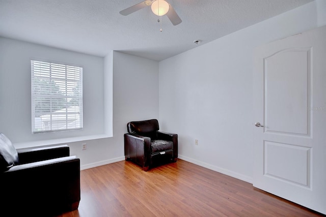 3782 Rollingsford Cir, Lakeland, FL 33810 - living area featuring wood finished floors, ceiling fan, and a textured ceiling