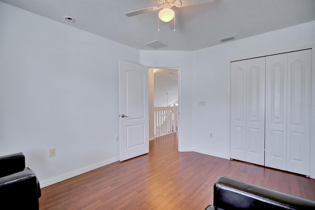 3782 Rollingsford Cir, Lakeland, FL 33810 - living area with wood finished floors, ceiling fan, and an upstairs landing