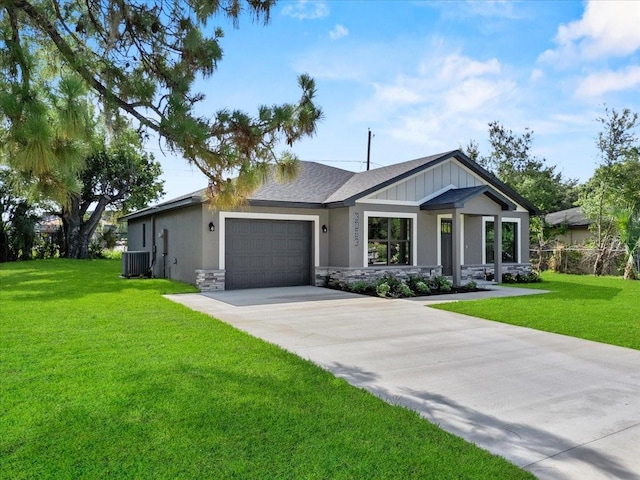 3063 Lantana Cir, Auburndale, FL 33823 - view of front facade with an attached garage, driveway, stone siding, and a front yard