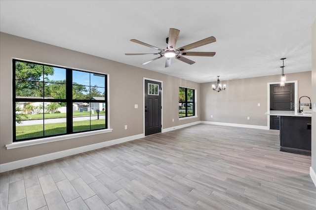3063 Lantana Cir, Auburndale, FL 33823 - unfurnished living room with a chandelier, ceiling fan, and light wood finished floors
