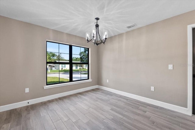 3063 Lantana Cir, Auburndale, FL 33823 - empty room with a chandelier and light wood finished floors