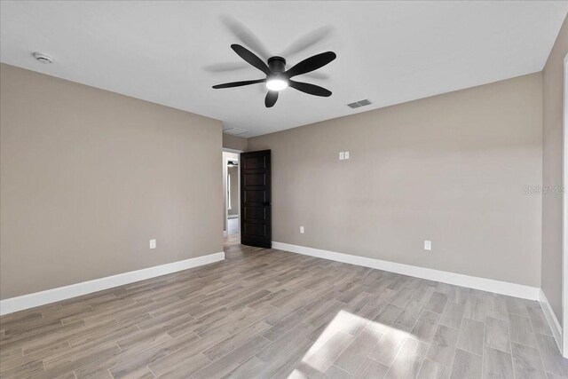 3063 Lantana Cir, Auburndale, FL 33823 - empty room with a ceiling fan, light wood-style flooring, and a smoke detector