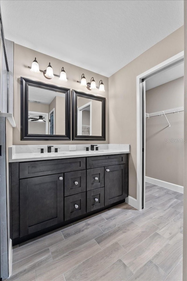 3063 Lantana Cir, Auburndale, FL 33823 - full bath with double vanity, a spacious closet, and wood tiled floors