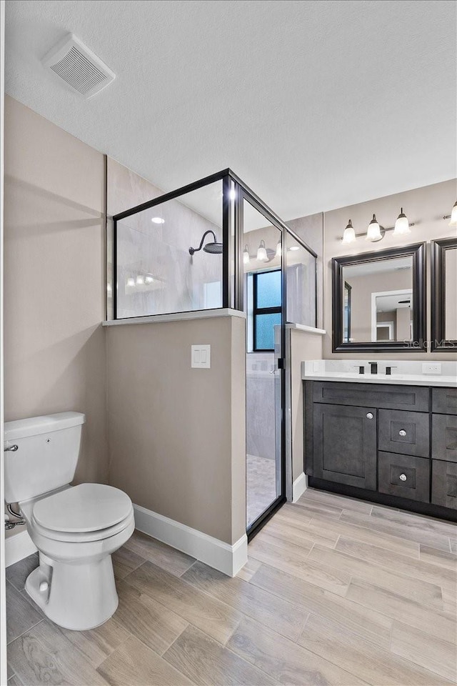 3063 Lantana Cir, Auburndale, FL 33823 - full bath with a shower stall, vanity, wood finished floors, and a textured ceiling