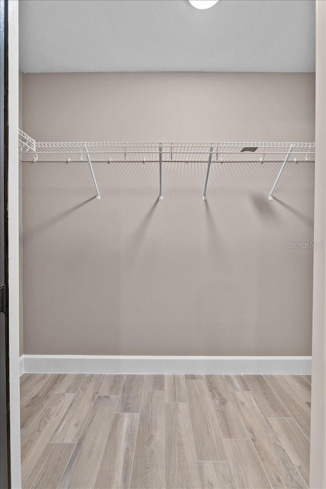 3063 Lantana Cir, Auburndale, FL 33823 - walk in closet featuring wood finished floors